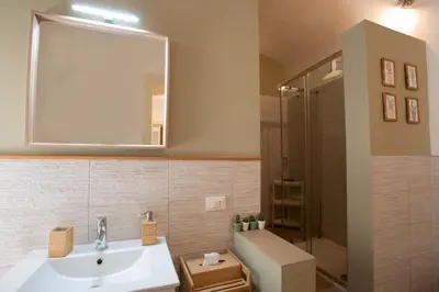 a bathroom with a sink and a shower with a mirror at Appartamento in centro Titi's place in Palermo