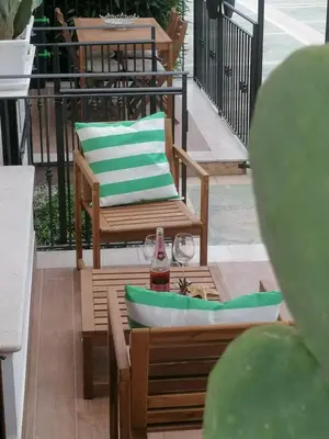 a chair and a bottle on a table on a patio at Stella del Mare San Vito Lo Capo in San Vito lo Capo