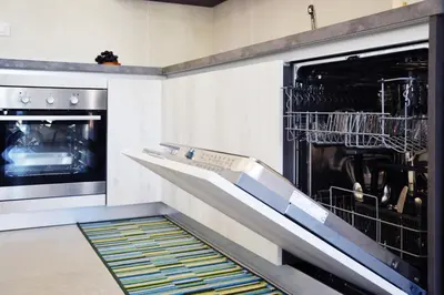 a kitchen with an oven with dishes in it at Splendida Villa NATURE-APPARTAMENTO MELOGRANO a SCOPELLO-ZINGARO vista sul mare in Scopello