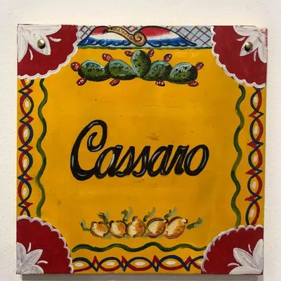 a sign for a casserole dish with vegetables on it at nonno peppe in Palermo