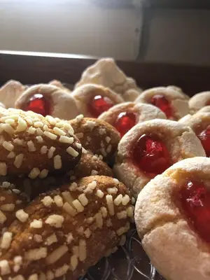 a bunch of pastries with cherries on top at nonno peppe in Palermo