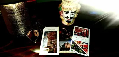 a table with pictures and a vase and a book at nonno peppe in Palermo