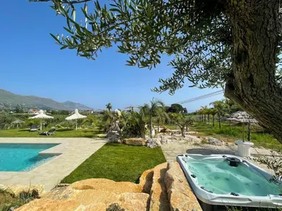 a bath tub in a yard next to a swimming pool at Splendida Villa NATURE- APPARTAMENTO ARANCIO a Scopello - Zingaro in Scopello