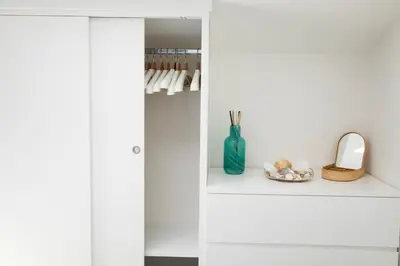 a white cabinet with a blue vase on a shelf at Splendida Villa NATURE- APPARTAMENTO ARANCIO a Scopello - Zingaro in Scopello