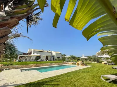 a villa with a swimming pool and a house at Splendida Villa NATURE- APPARTAMENTO ARANCIO a Scopello - Zingaro in Scopello