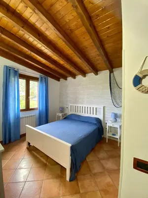a bedroom with a bed and a wooden ceiling at Villa Marcione Garden & House in Cinisi