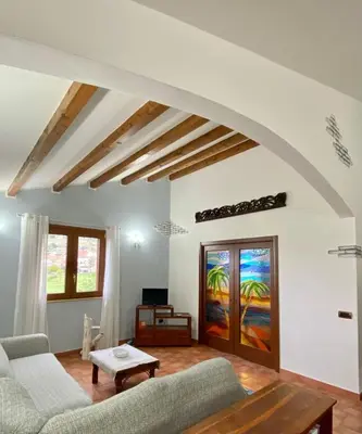 a living room with a couch and a table at Villa Marcione Garden & House in Cinisi