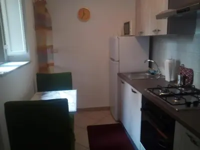 a small kitchen with a sink and a refrigerator at La Casetta di Dafne in Palermo