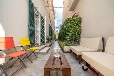 a balcony with chairs and a coffee table at L'Angolino di Anna in Mondello