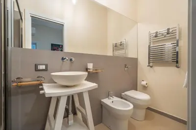 a bathroom with a sink and a toilet at L'Angolino di Anna in Mondello