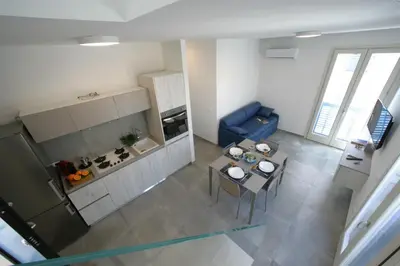 an overhead view of a kitchen and a living room at ITACA e MEDEA - Appartamenti con idromassaggio in terrazza in San Vito lo Capo