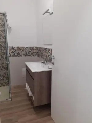 a bathroom with a sink and a mirror at Bed and Breakfast Stella del Sud Makari in Macari