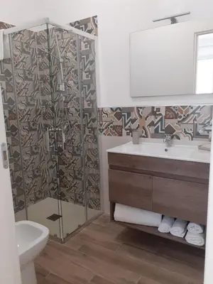 a bathroom with a toilet and a sink and a mirror at Bed and Breakfast Stella del Sud Makari in Macari