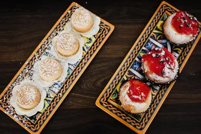 two plates of pastries on a wooden table at AWA Mondello in Mondello
