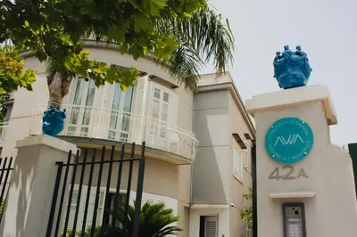 a building with a sign on the side of it at AWA Mondello in Mondello