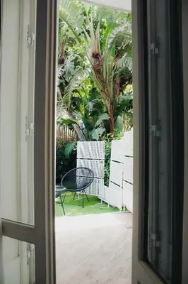 a door leading to a patio with a table and chairs at AWA Mondello in Mondello
