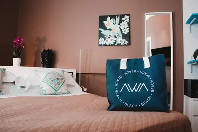 a bed with a blue and white pillow on it at AWA Mondello in Mondello