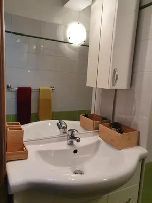 a bathroom with a white sink and a mirror at Casa vacanza Corallo in Castellammare del Golfo