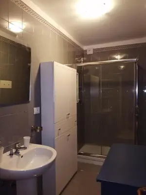 a bathroom with a sink and a shower at Da Ale alla Cattedrale in Palermo