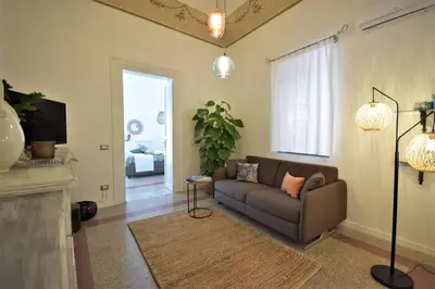 a living room with a couch and a fireplace at La Casetta 90139 in Palermo