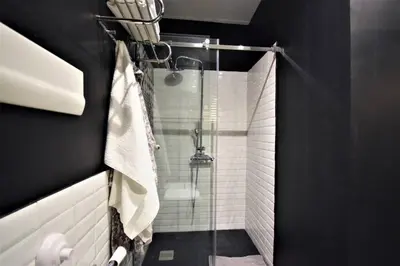 a bathroom with a shower with a glass door at La Casetta 90139 in Palermo