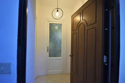 a hallway with a door and a light fixture at La Casetta 90139 in Palermo