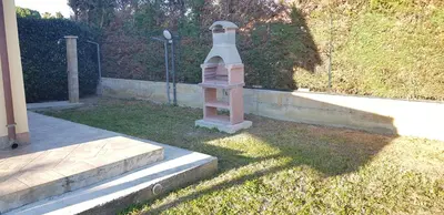 a small pink lighthouse sitting in the grass at Case Vacanze Paradise Beach Vicino Cefalù PISCINA APERTA in Campofelice di Roccella