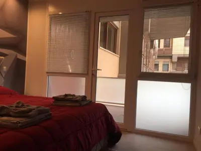 a bedroom with a bed and a large window at George House Palermo in Palermo