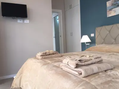 a bedroom with a bed with towels on it at George House Palermo in Palermo