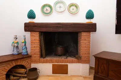 a brick fireplace with plates on a wall at Feudo Giglio Country Charme in Calatafimi
