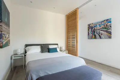 a bedroom with a bed and a painting on the wall at Loft Trinacria con Vista Mare by Wonderful Italy in Palermo