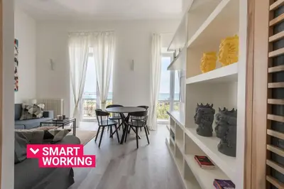 a living room with a table and a dining room at Loft Trinacria con Vista Mare by Wonderful Italy in Palermo