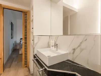 a bathroom with a white sink and a mirror at Loft Trinacria con Vista Mare by Wonderful Italy in Palermo