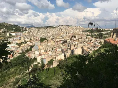 a city on top of a hill with buildings at La Domus di Segesta in Calatafimi