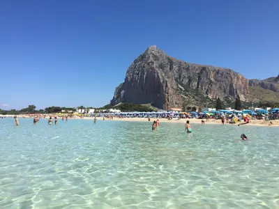 a group of people in the water at a beach at La Domus di Segesta in Calatafimi