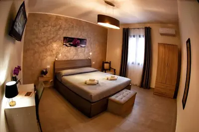a bedroom with a bed with two towels on it at La Domus di Segesta in Calatafimi