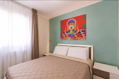 a bedroom with a bed and a painting on the wall at Azzurra Apartments in Balestrate