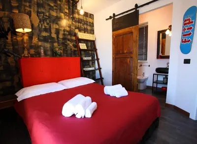 a bedroom with a red bed with towels on it at Accardi House Searooms in Palermo