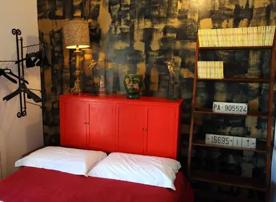 a red cabinet in a room with a wall at Accardi House Searooms in Palermo