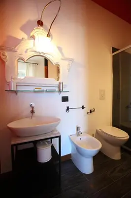 a bathroom with a sink and a toilet and a mirror at Accardi House Searooms in Palermo
