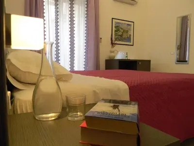 a bedroom with a bed and a table with a lamp at B&B Oreto Centro in Palermo