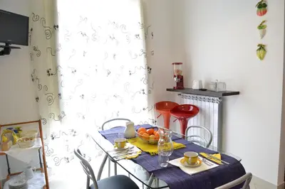 a table with a bowl of fruit on it at B&B Oreto Centro in Palermo