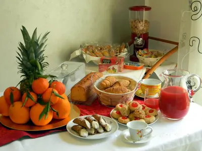 a table with a bunch of food on it at B&B Oreto Centro in Palermo