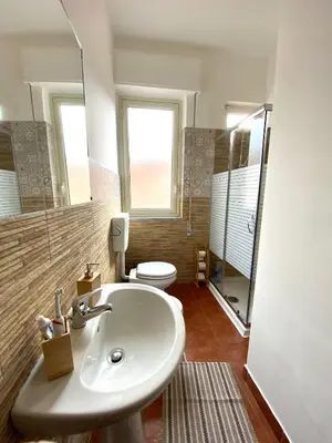 a bathroom with a sink and a toilet at Casa dello Spasimo in Palermo