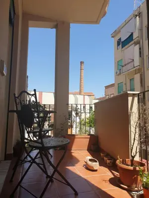 a balcony with a chair and a view of a building at Casa dello Spasimo in Palermo
