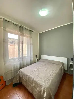 a bedroom with a large bed and a window at Casa dello Spasimo in Palermo