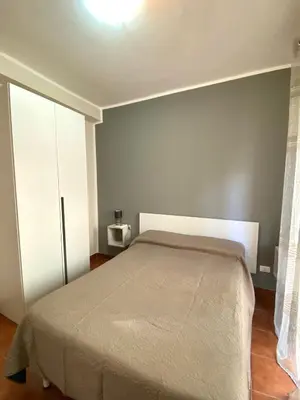 a bedroom with a bed and a white cabinet at Casa dello Spasimo in Palermo