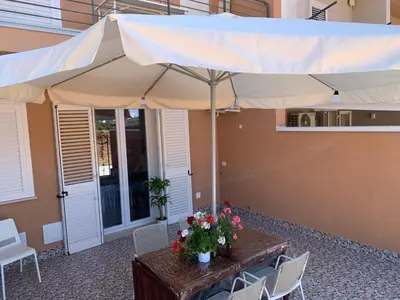 a table with a large umbrella on a patio at Le Case Vacanze di Federico in Terrasini