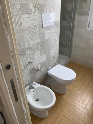 a bathroom with a toilet and a sink at Le Case Vacanze di Federico in Terrasini