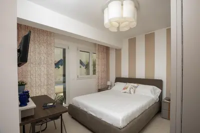 a bedroom with a bed and a desk and a television at Kafara Resort- Villas and Pool by Lisca Bianca Rental in Santa Flavia